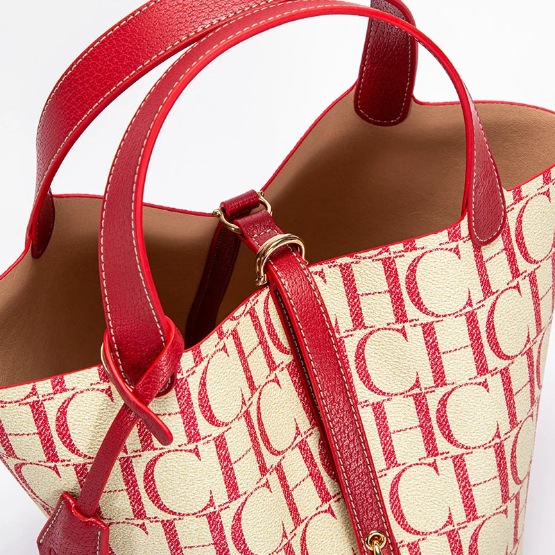 Red and beige handbag with a prominent brand logo on a white background