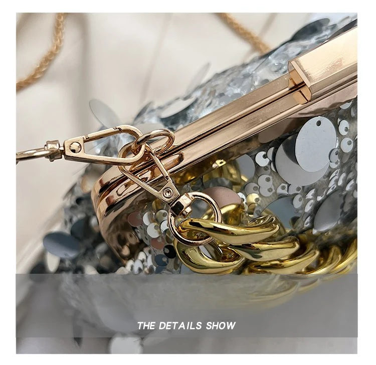 Close-up of a gold keychain with intricate design on a textured surface