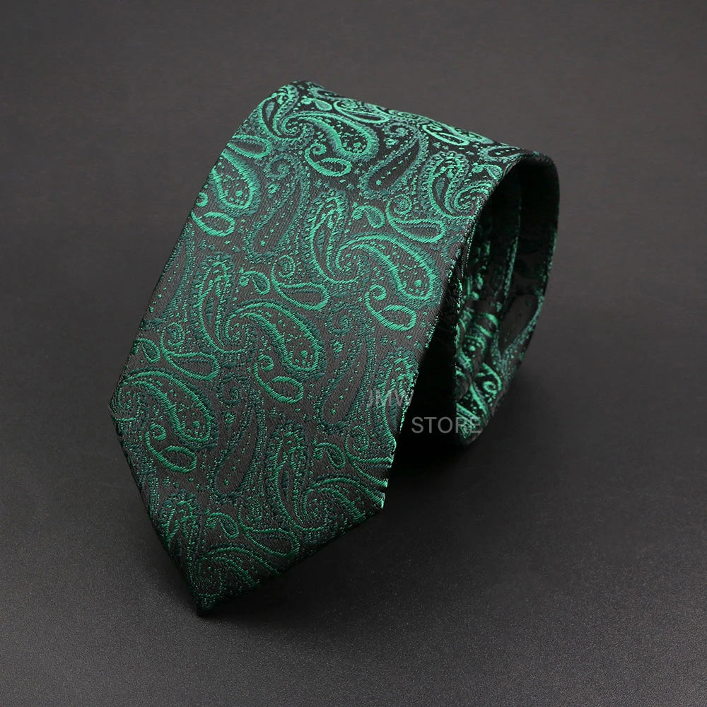 Green paisley patterned tie on a dark gray background
