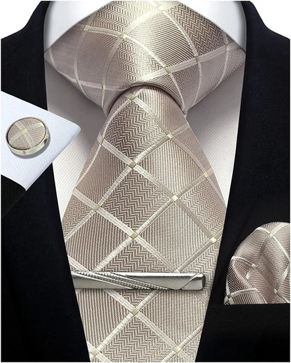 Silver patterned tie with matching cufflinks and pocket square on a black suit.